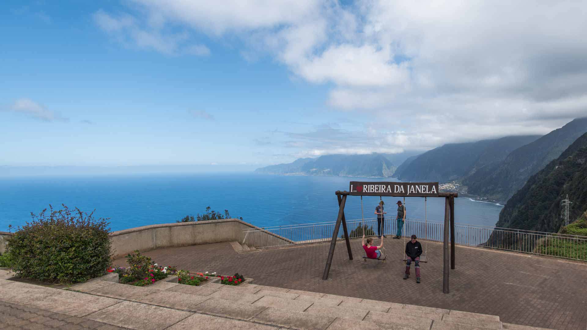 Viewpoint with swing overlooking the coast, mountain, and sea in Madeira.