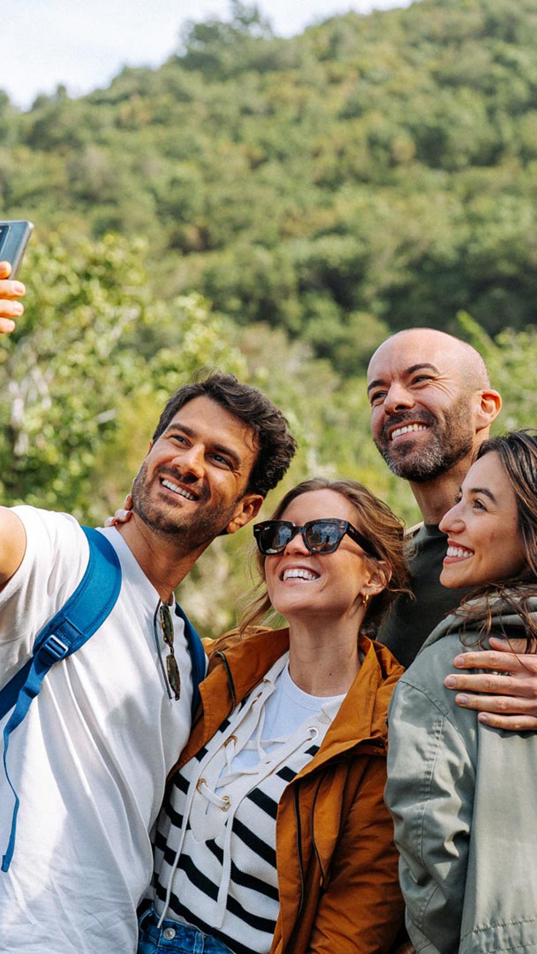 Group of friends hiking and taking a selfie.