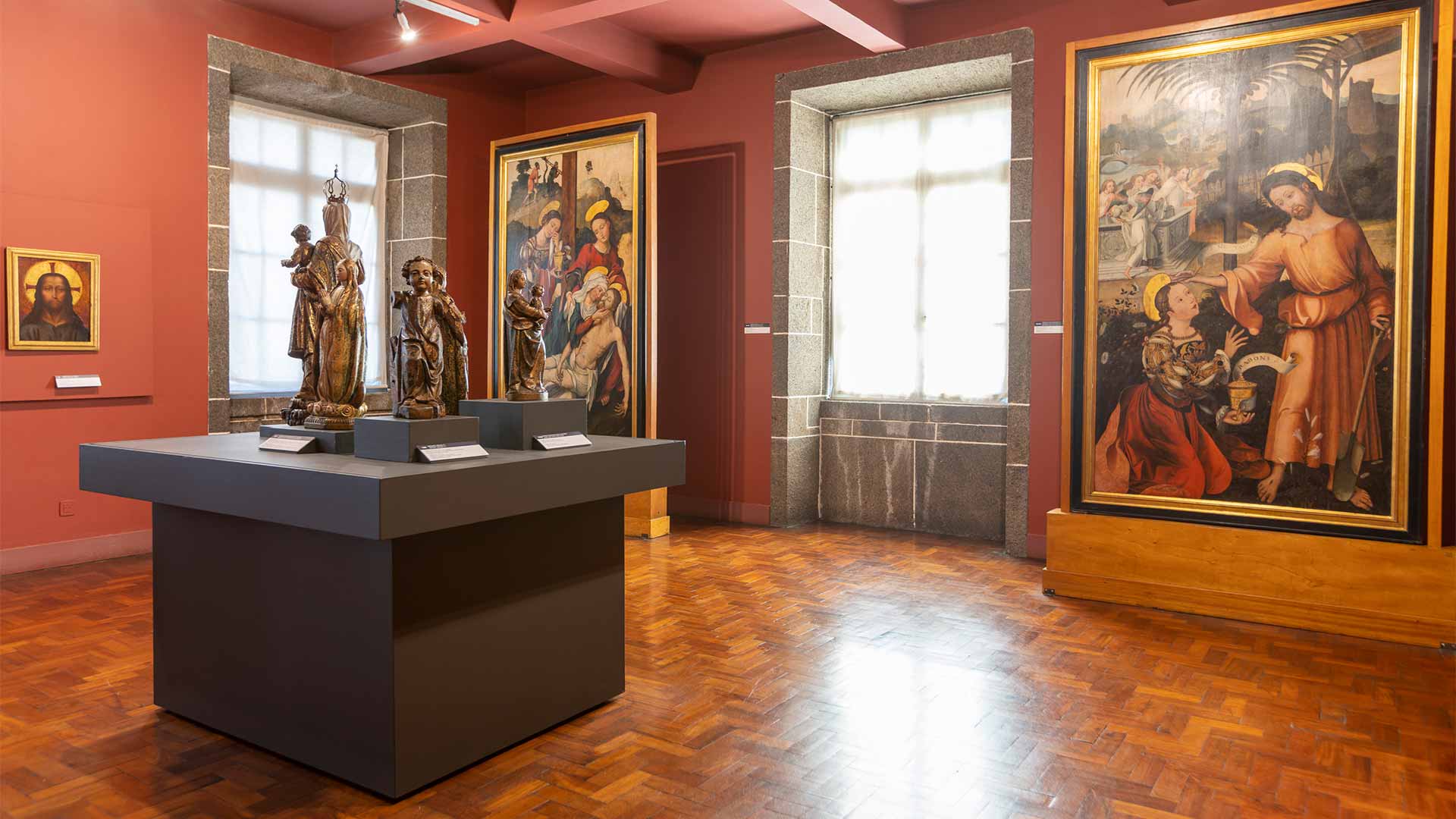 Museum with statues and paintings on display.