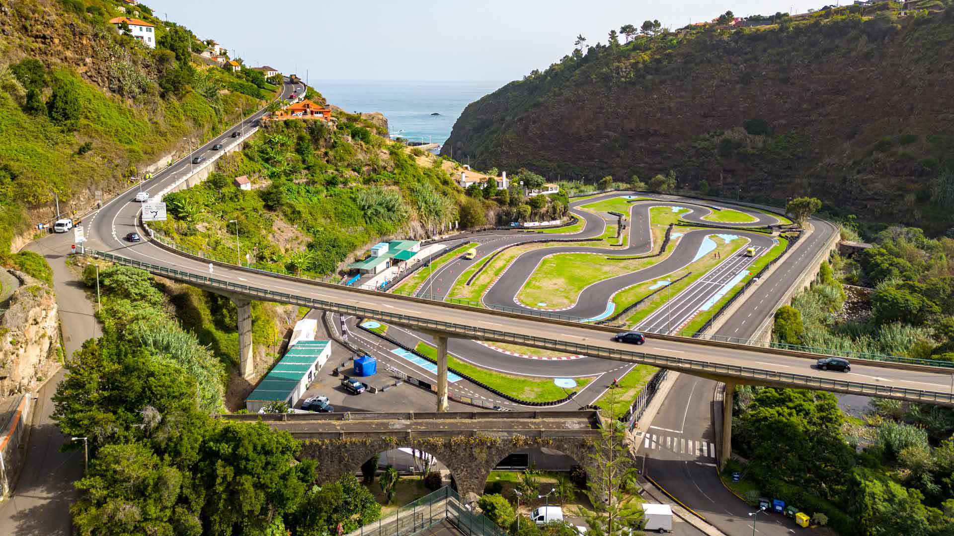 Bridge over roads among green mountains.
