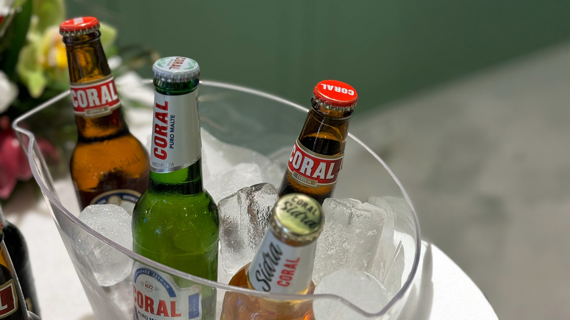 Four bottles of beer and cider in an ice bucket, ready to serve.