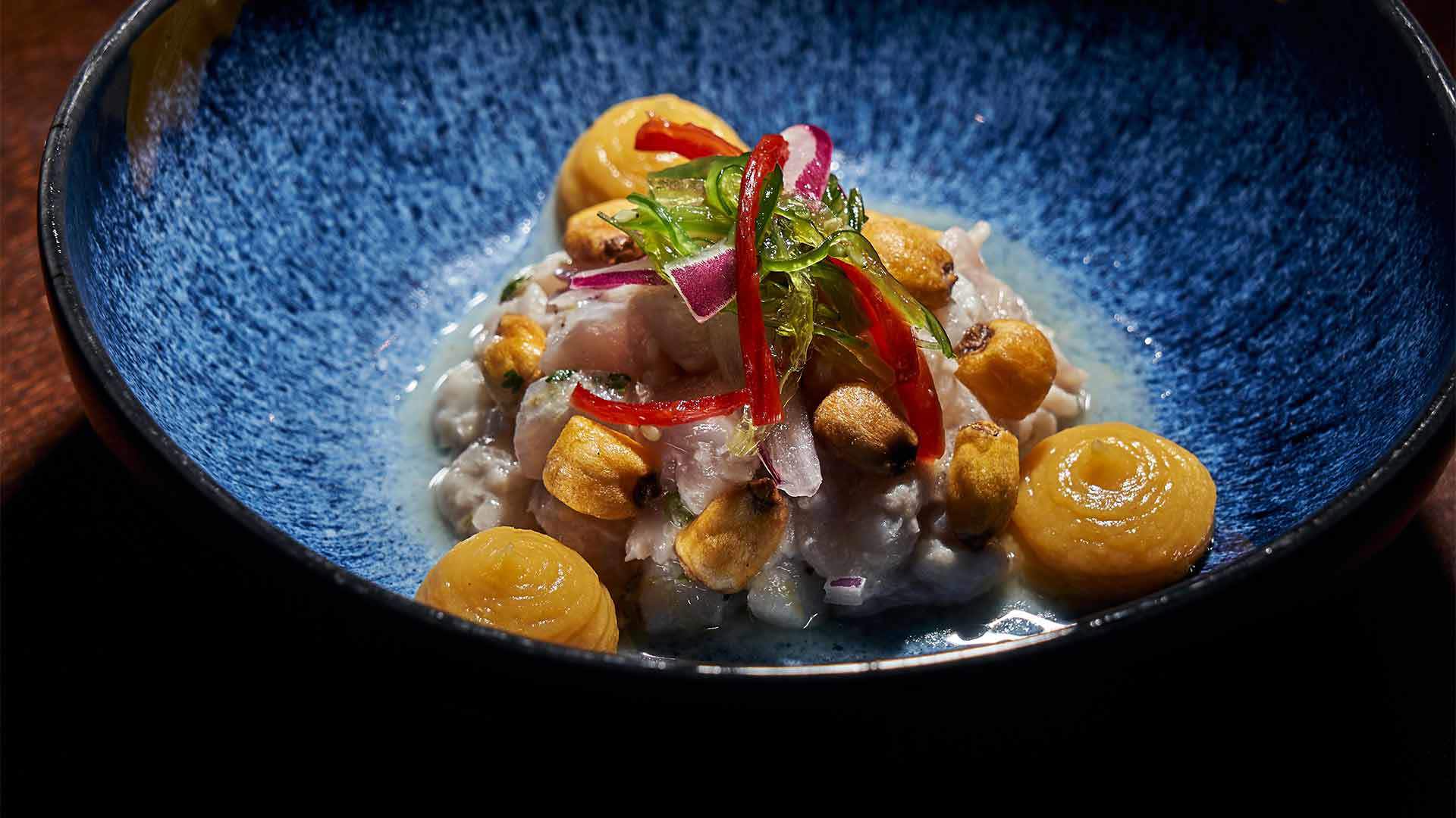 Deep plate with fish and yellow sauce.