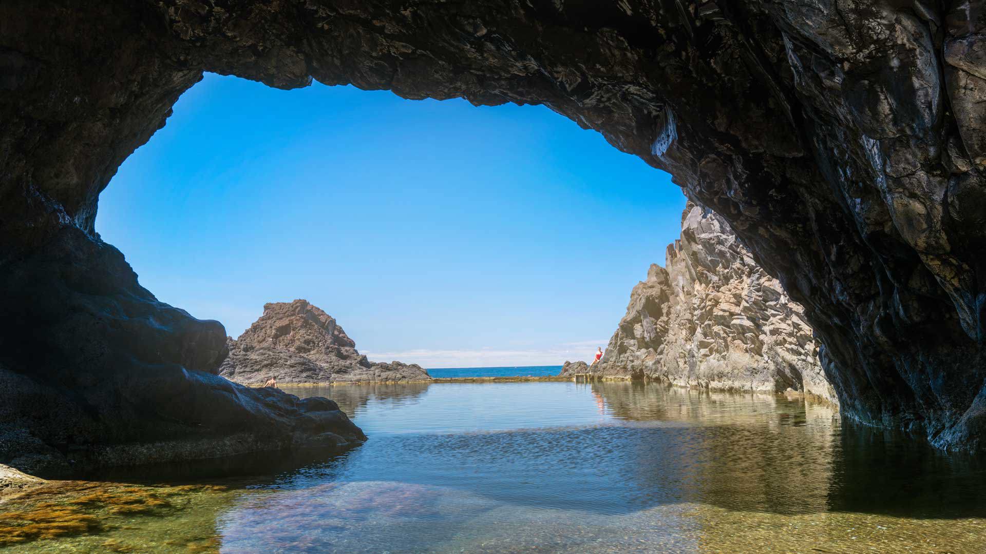 Natural pool surrounded by rocks on Madeira’s coast.