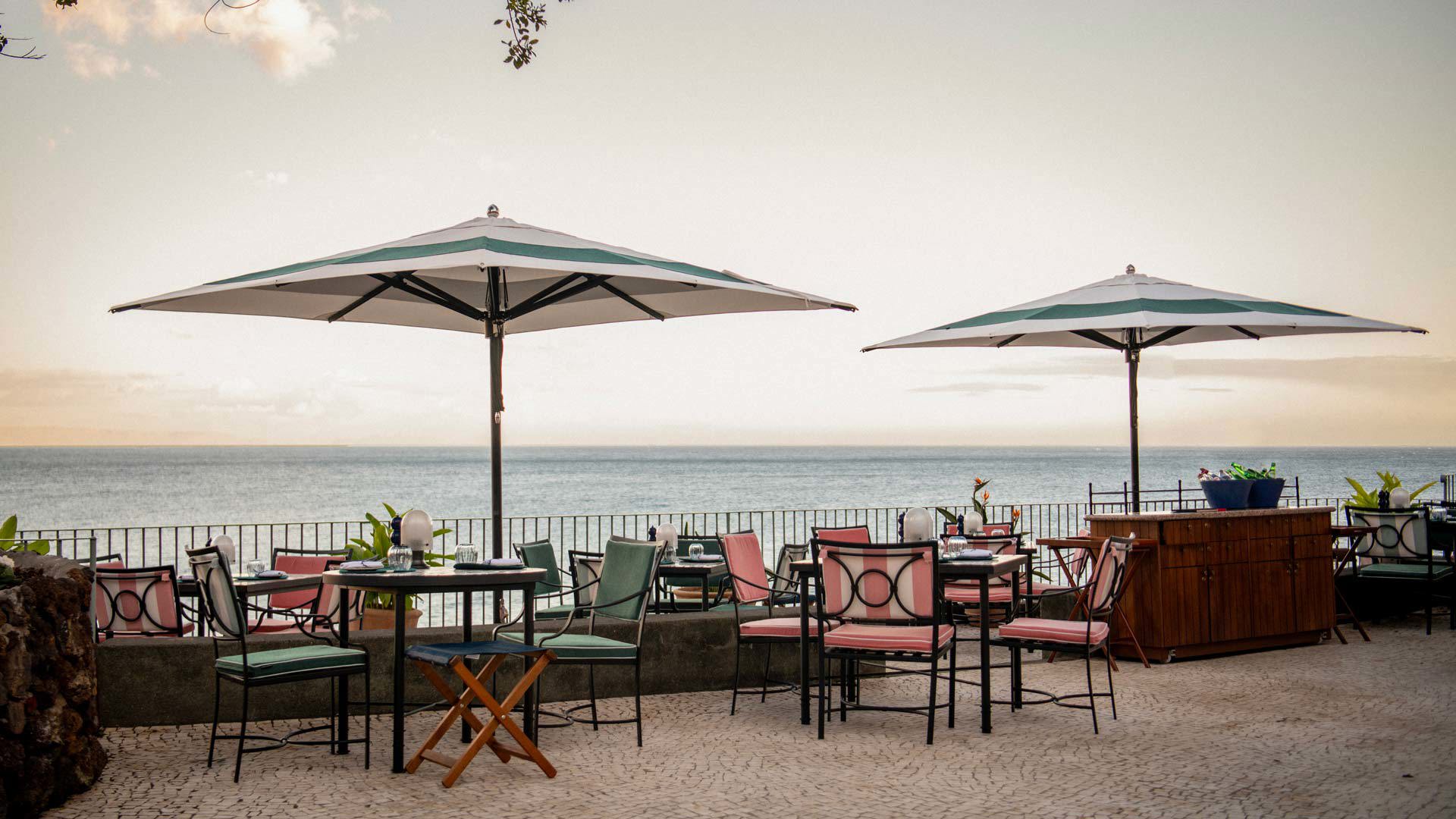 Terrace at Brisa do Mar restaurant at Reid’s Palace, with parasols and sea views on Madeira Island.