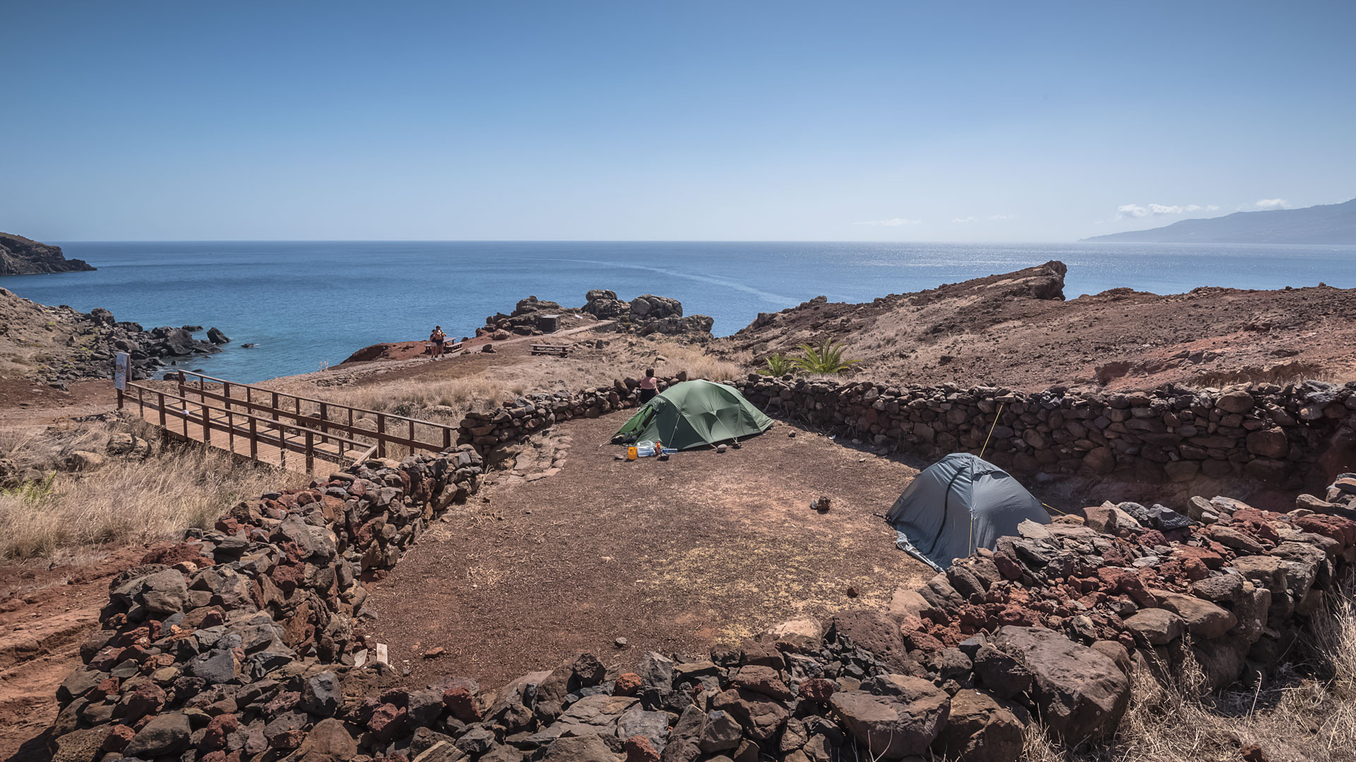 Campsite with two tents by the sea.