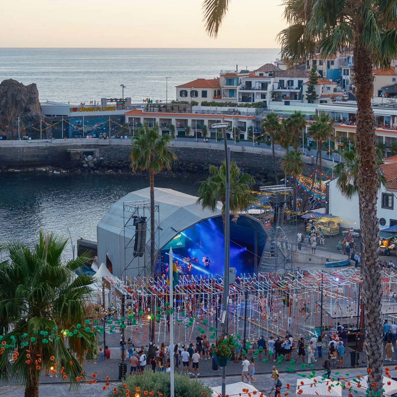 Câmara de Lobos Bay during the festival, with a stage, entertainment and sea views.