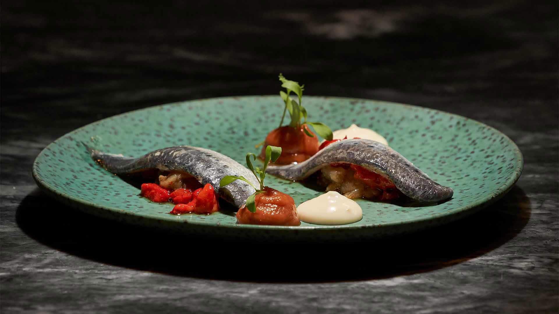 Fish dish with sauces and peppers.