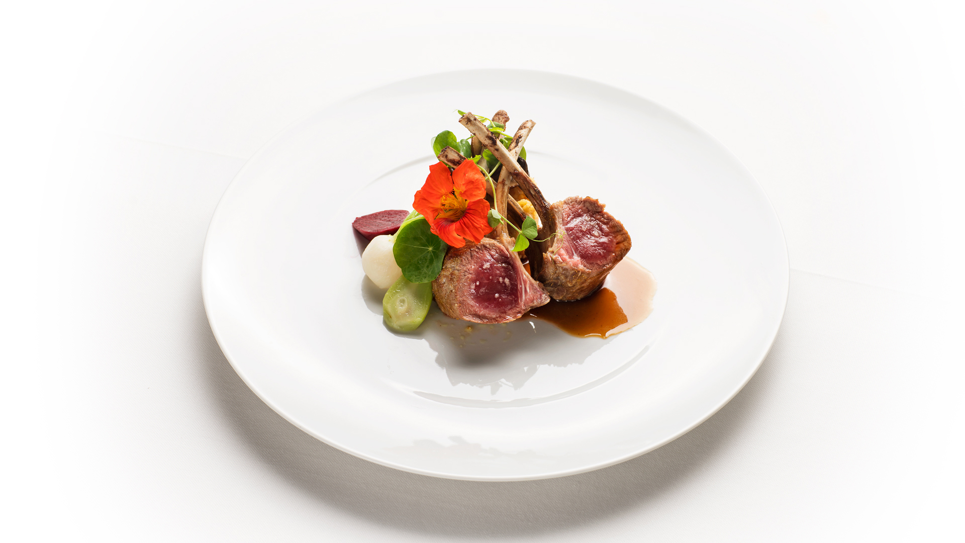 Plate of food with meat and green vegetables.