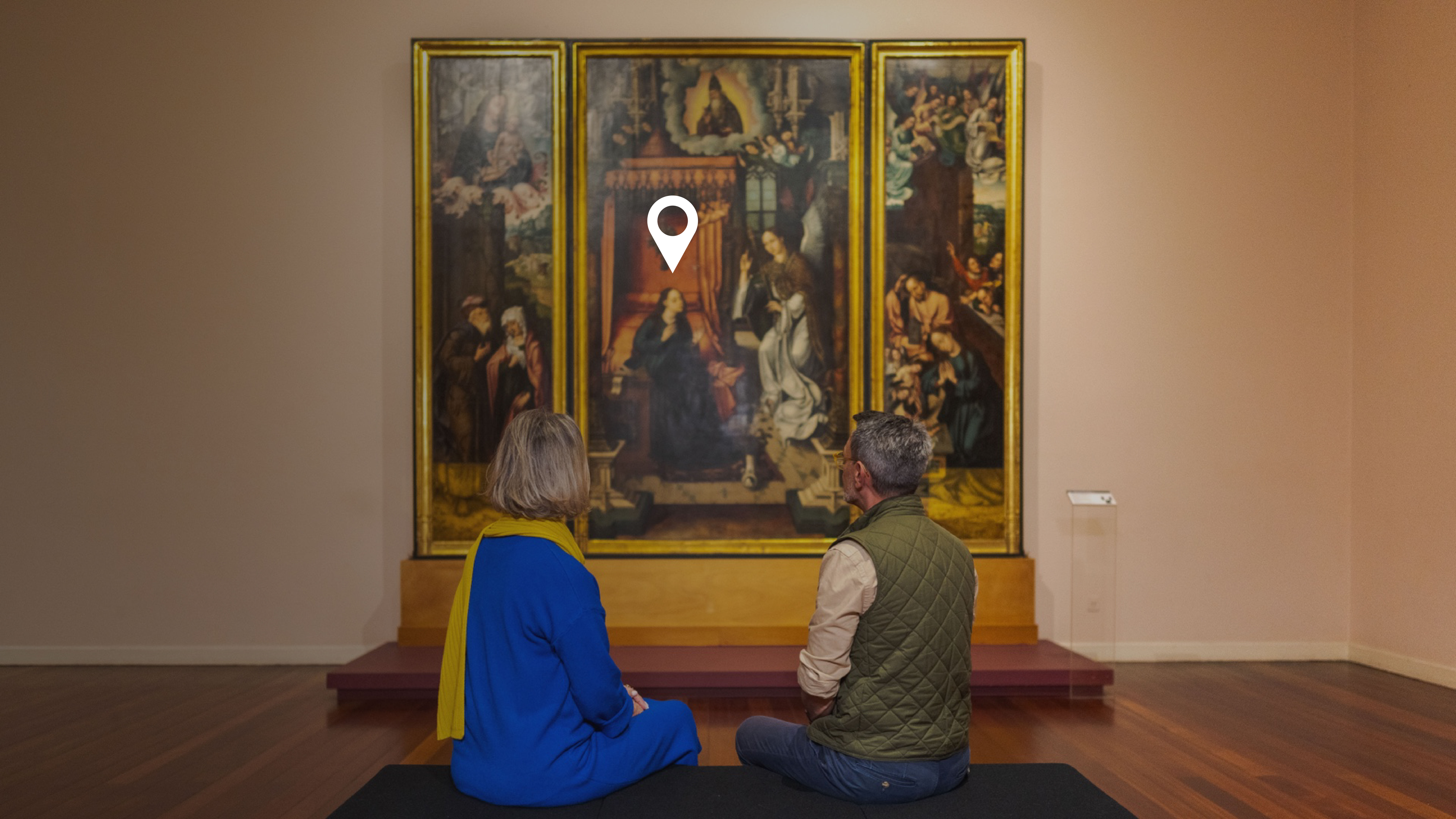 Old couple looking at a painting