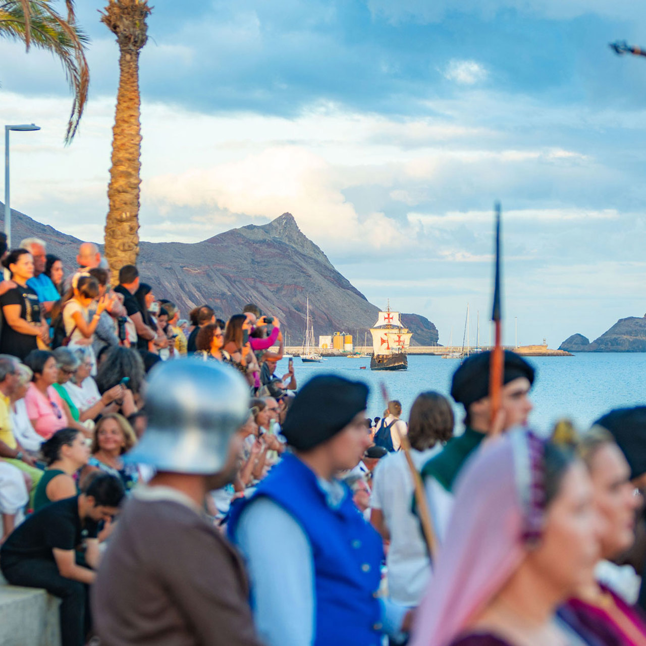 Audience at the Columbus Festival in Porto Santo watching a carrack at sea.