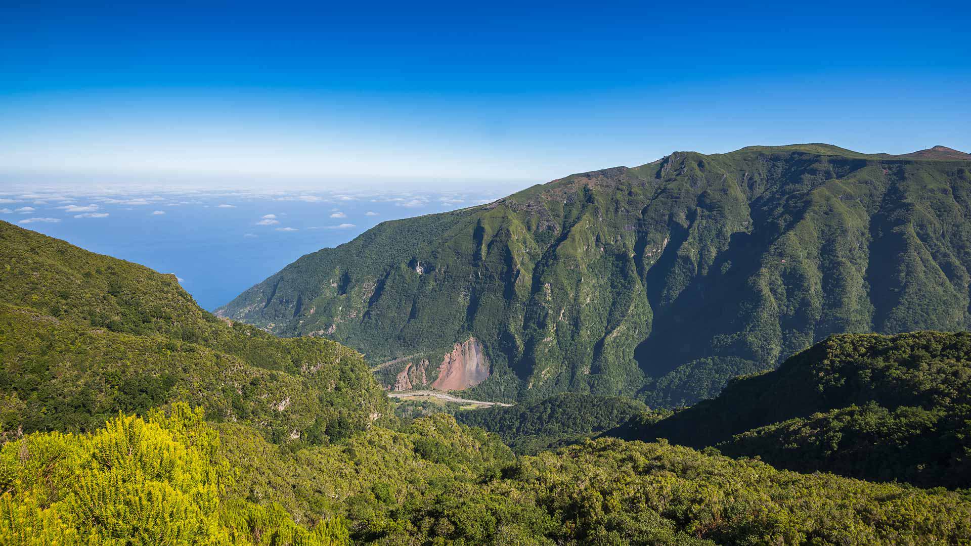 Valley between mountains with lush natural landscape.