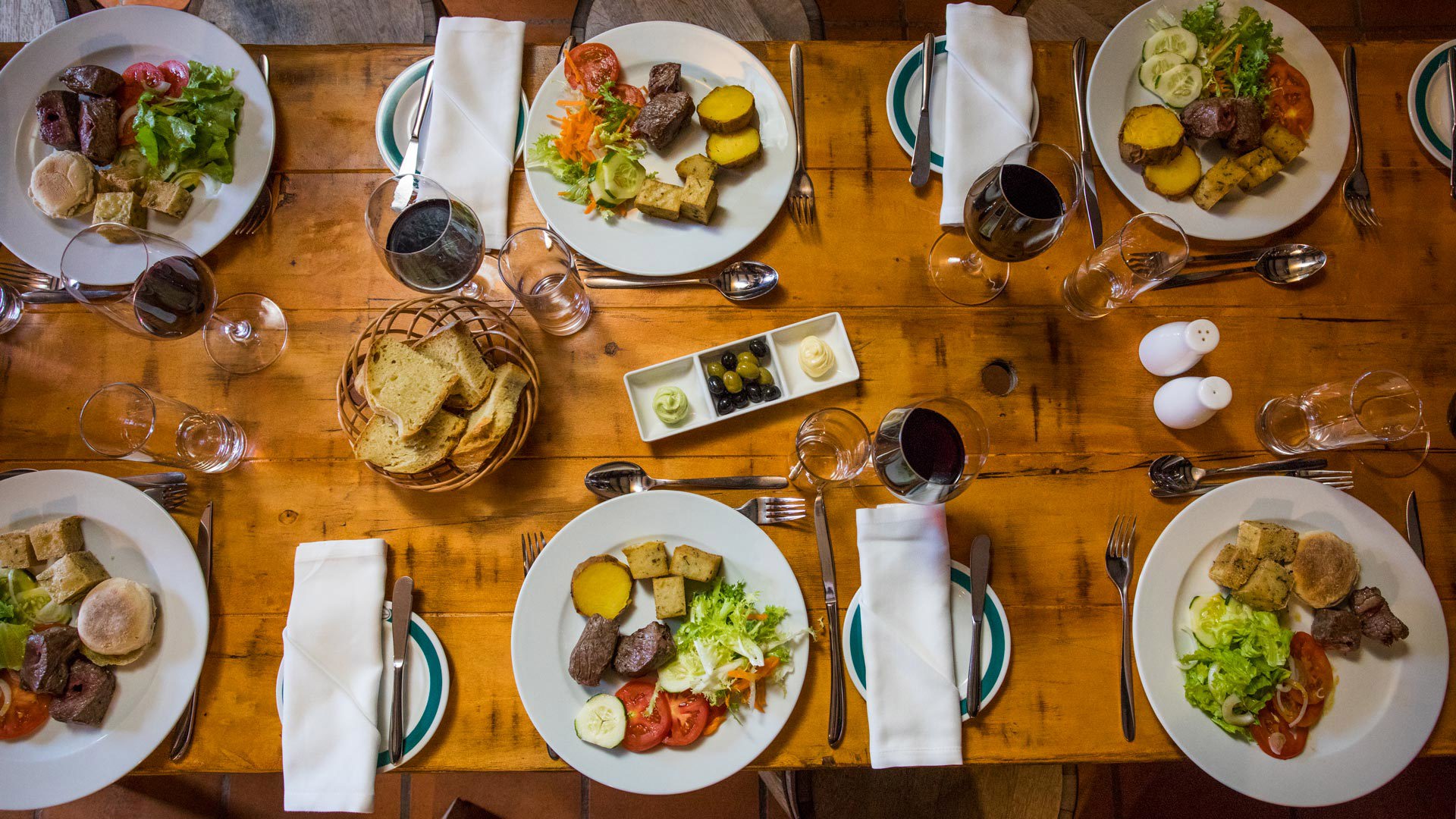 Table set with dishes and glasses of wine for a meal on Madeira Island.