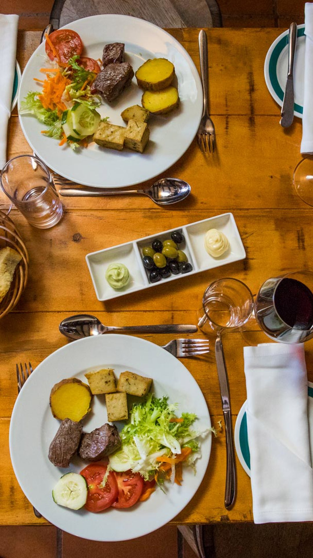Table set with dishes and glasses of wine for a meal on Madeira Island.