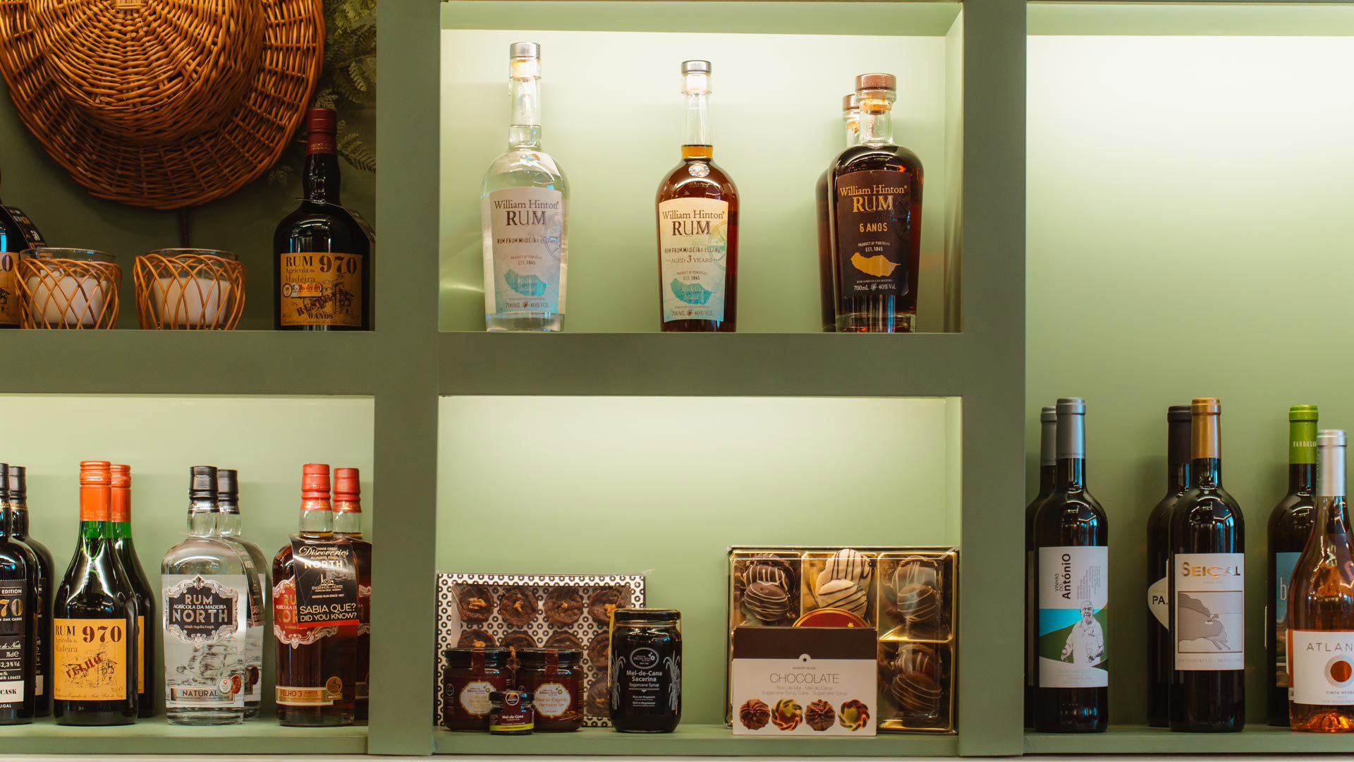 Shelves at the Madeira Tourism Office in Lisbon displaying rum and other regional products.
