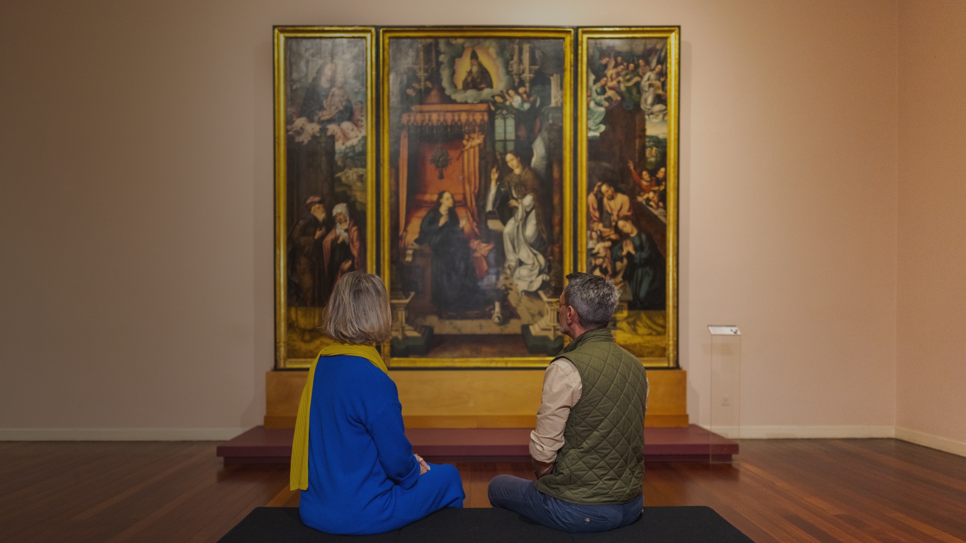 Old couple looking at a painting