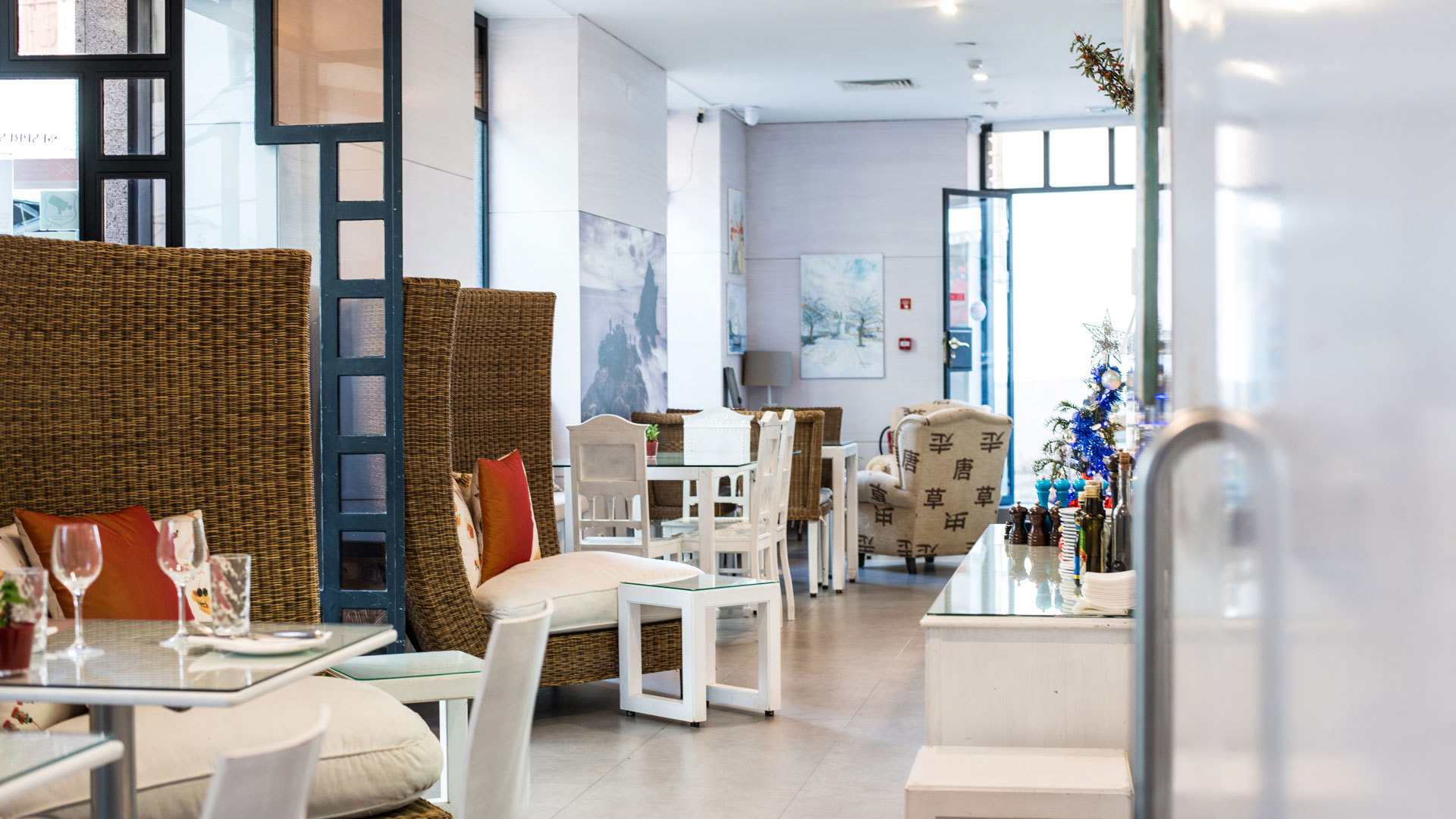 Tables decorated with glasses and large brown chairs.