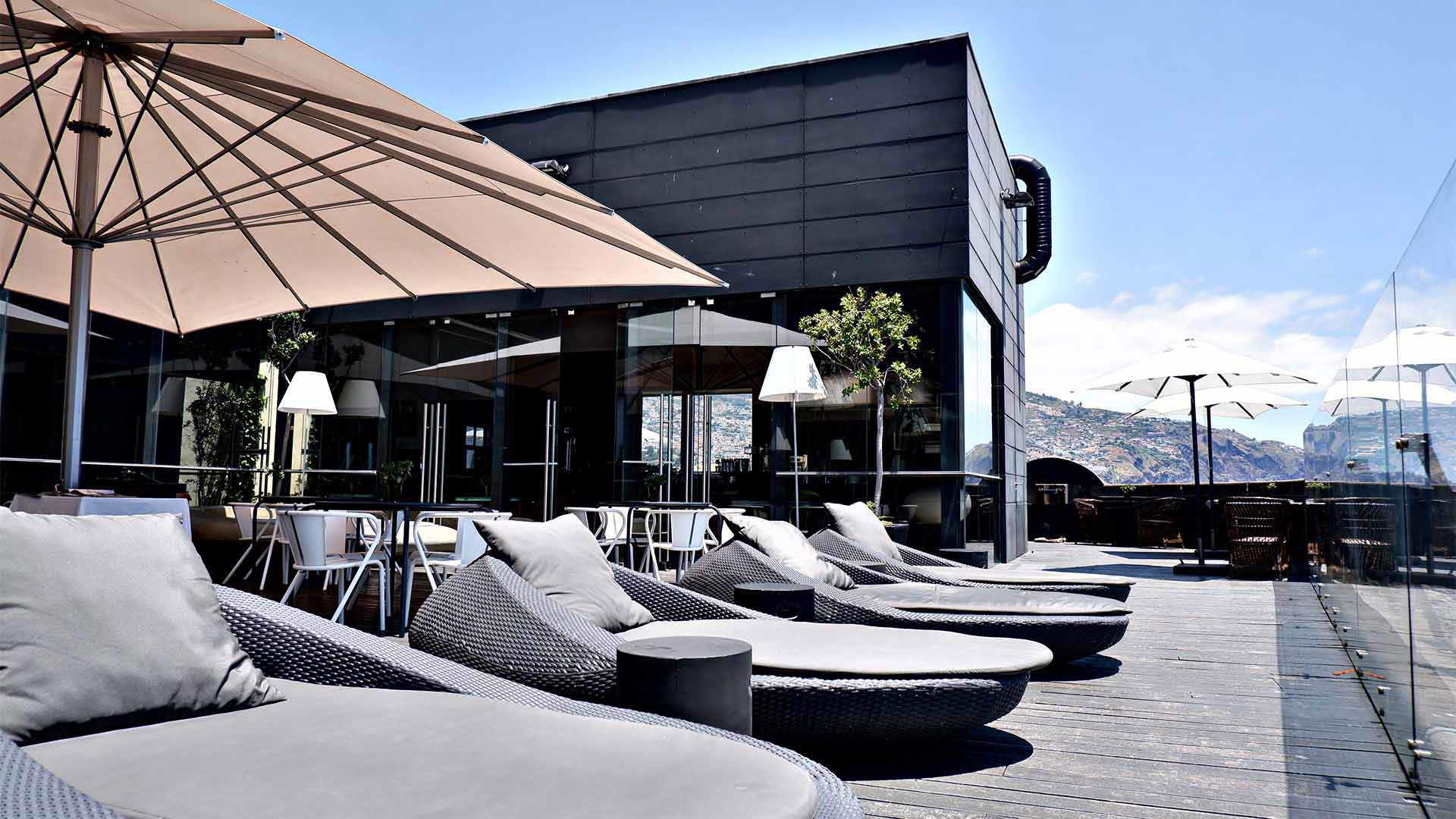 Sun loungers under a parasol in the sun.