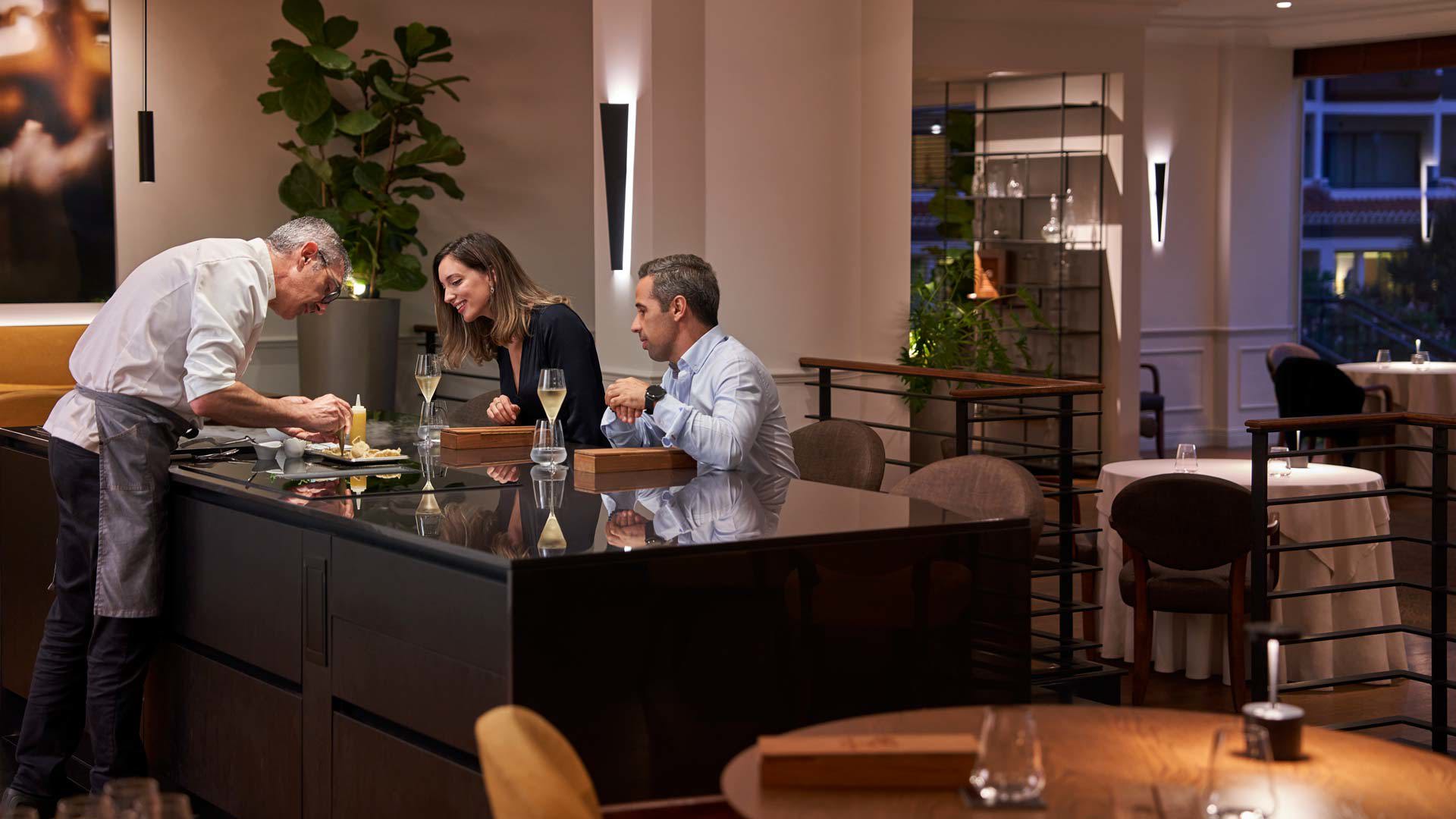 Couple enjoying a meal tasting in a private restaurant.