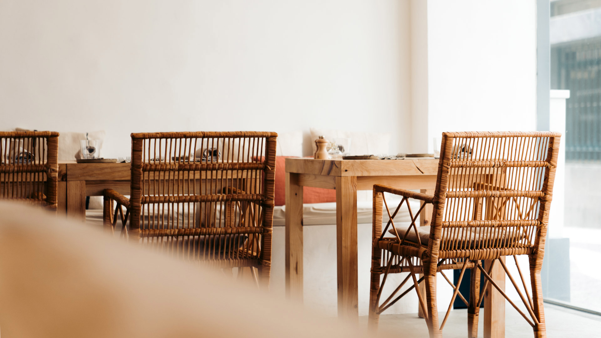 Wooden chairs arranged by tables.