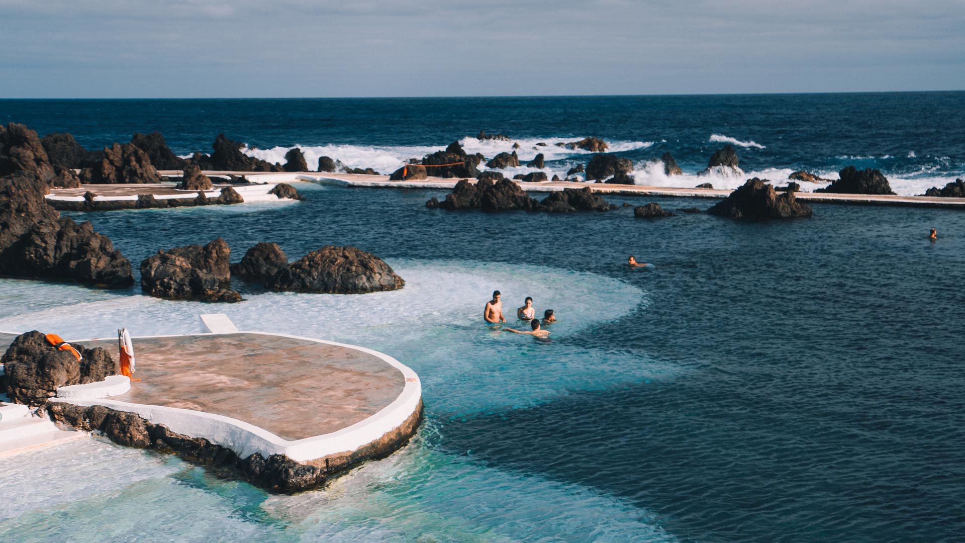 People enjoying the natural pools of Porto Moniz, Madeira.