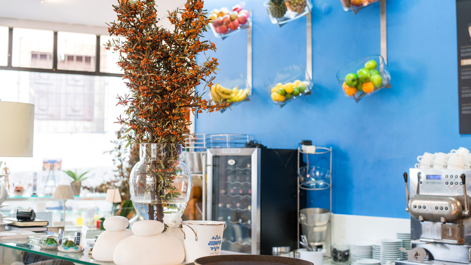 Counter decorated with flowers and displayed fruit.