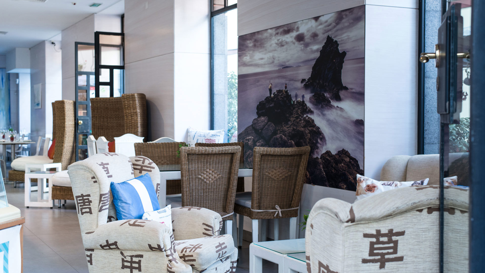 White sofas with brown chairs around them.