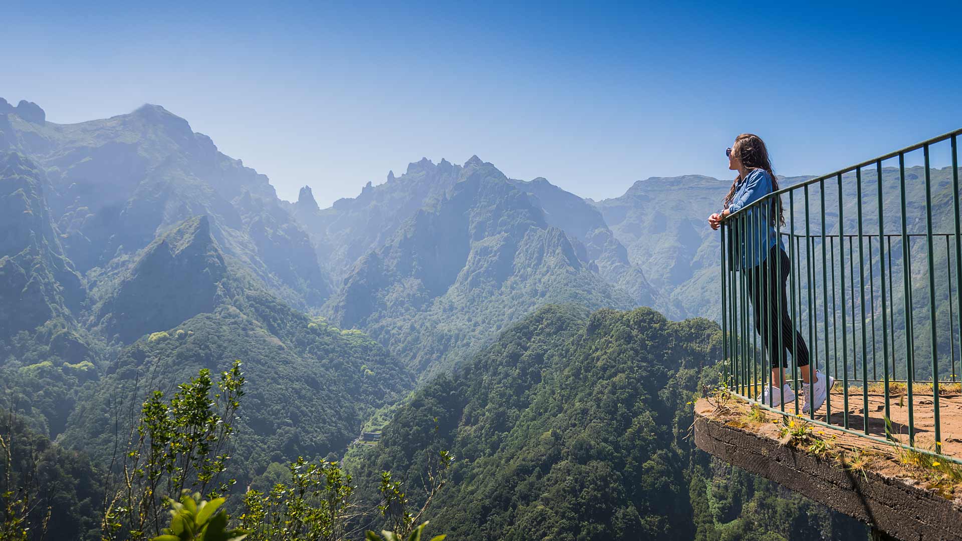 Woman at a viewpoint overlooking the mountain.