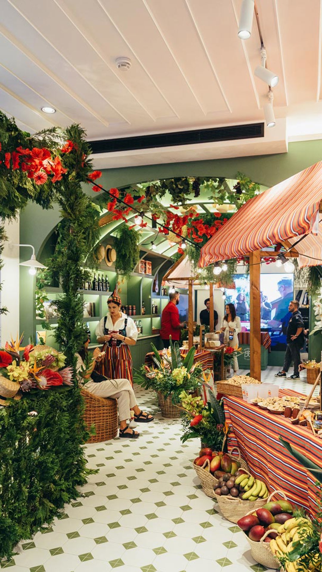Madeira Tourism Office space in Lisbon during an event, featuring a decorated stall with colorful flowers.