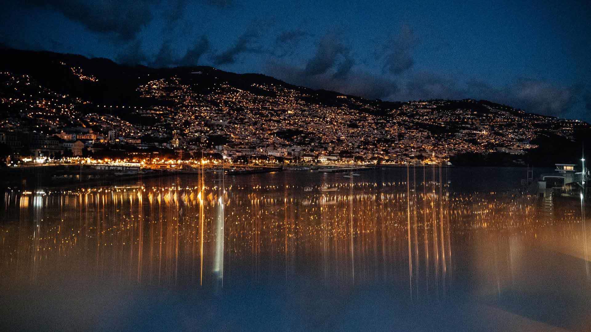 Funchal Bay illuminated at night.