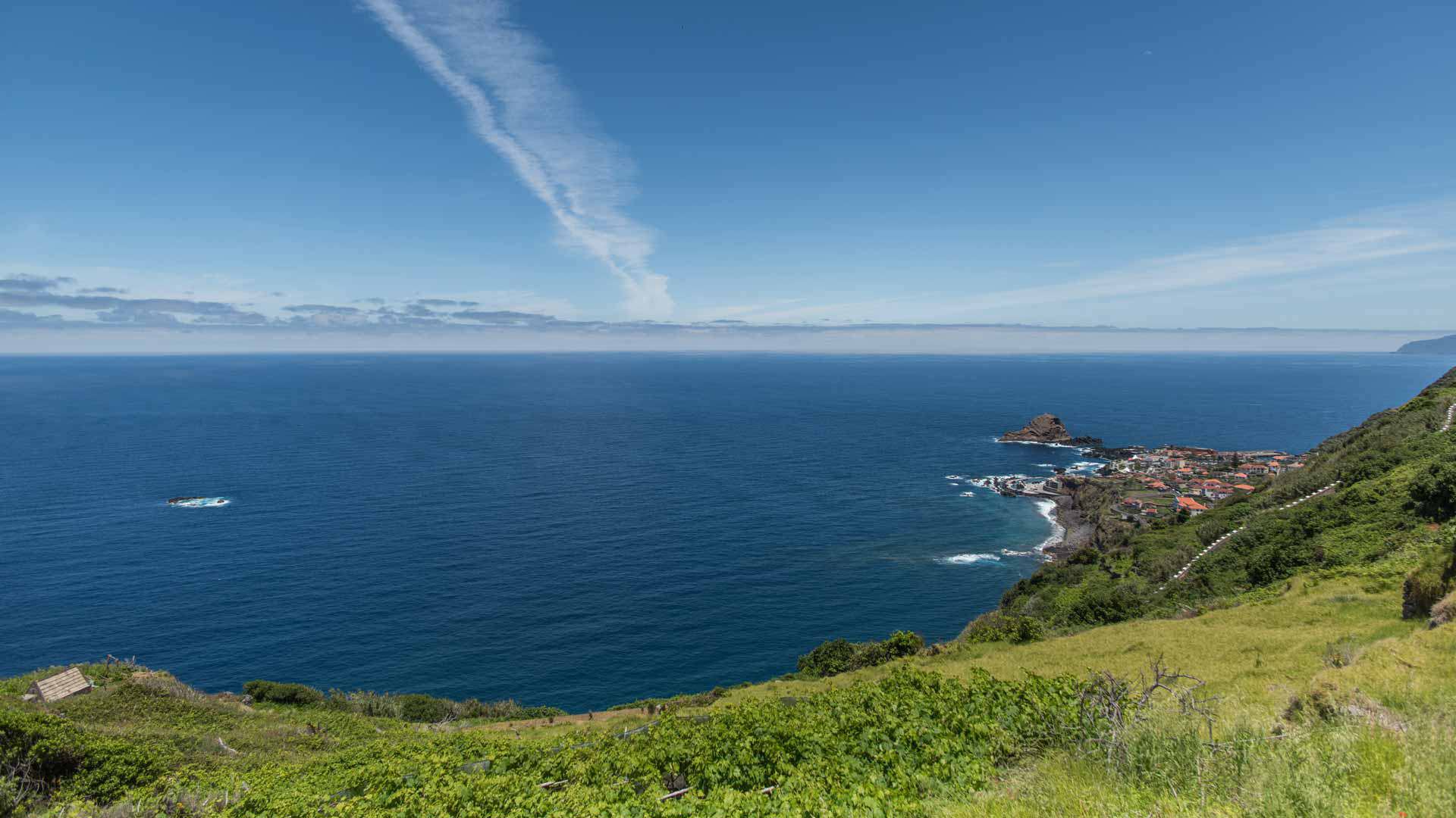 Viewpoint overlooking the sea and green hillside.