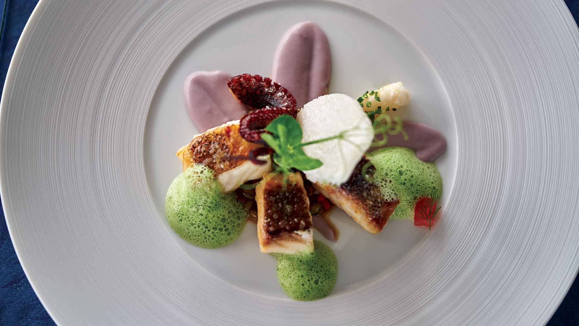 White plate with a plated meal in contemporary cuisine style at the Ritz.