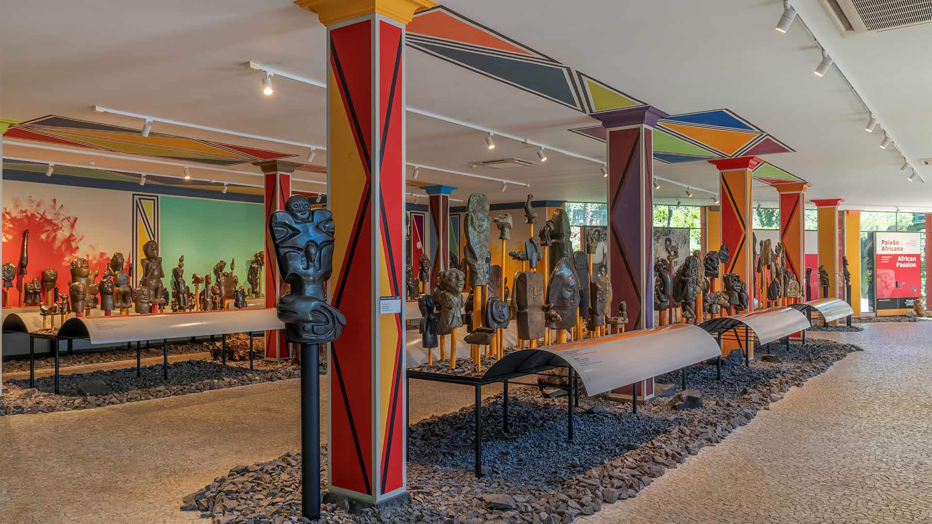 Exposition africaine au Musée Monte Palace avec des sculptures et des piliers colorés