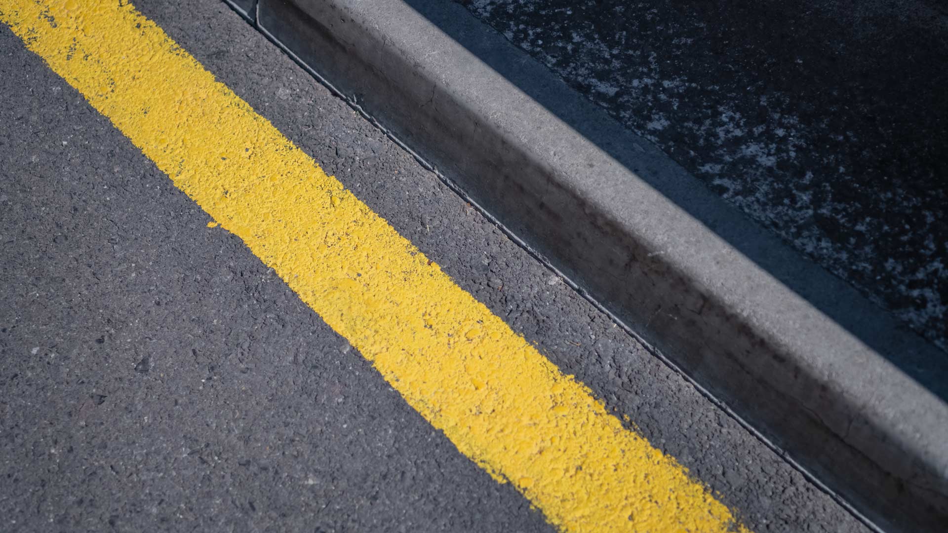 Road with a yellow line painted on the asphalt.