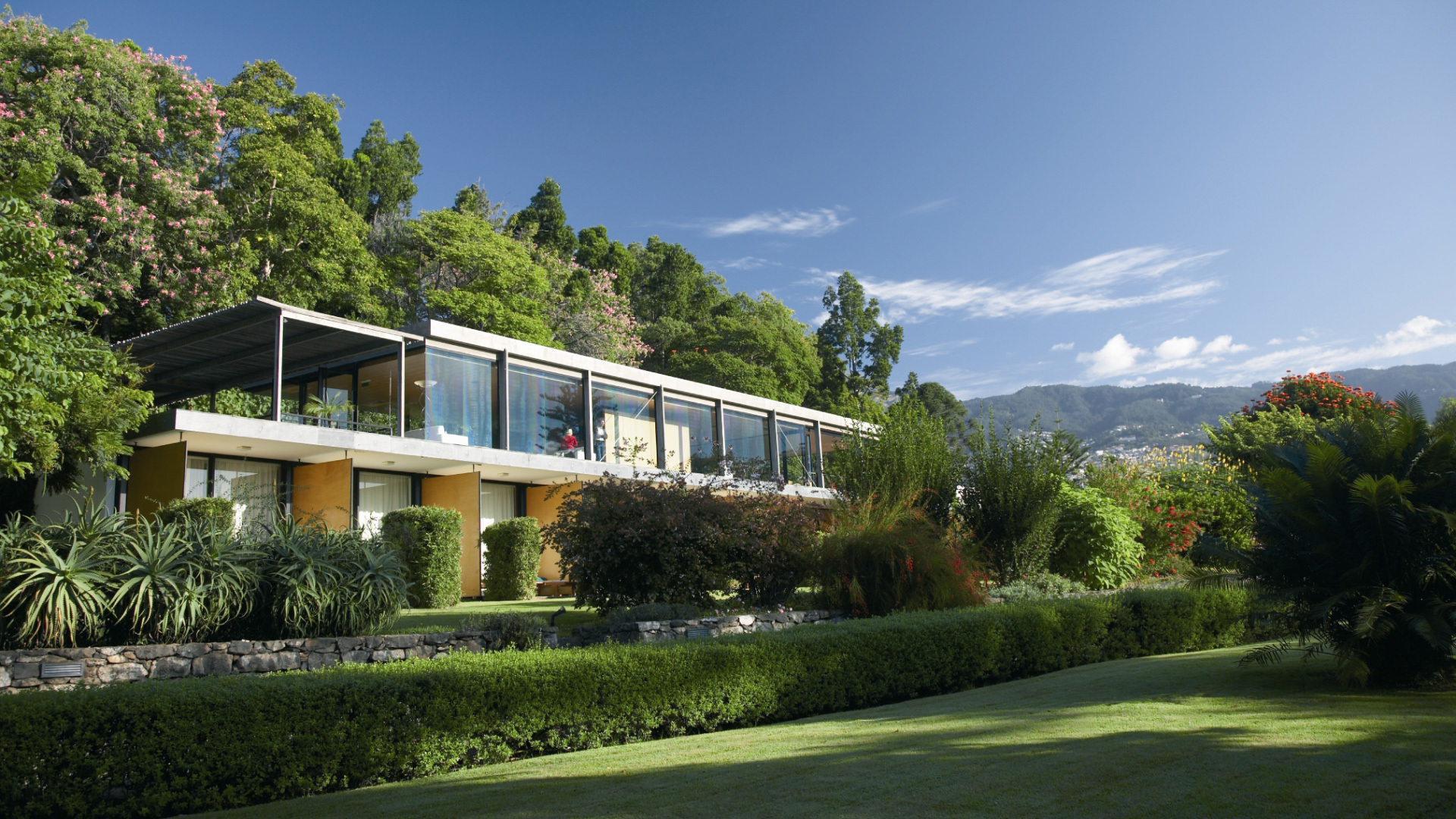 Rectangular building situated amidst vegetation.
