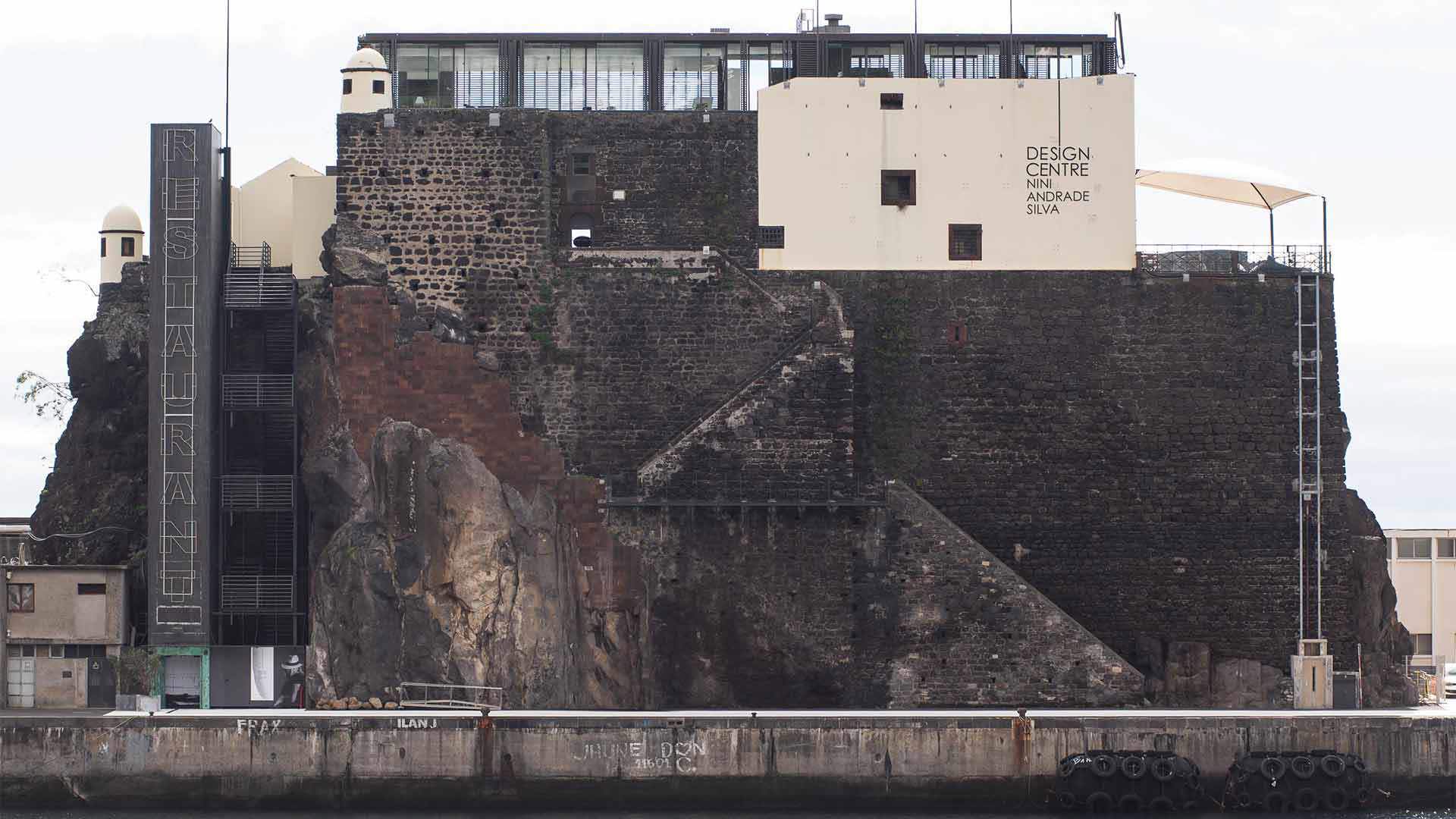 White building atop a stone structure.