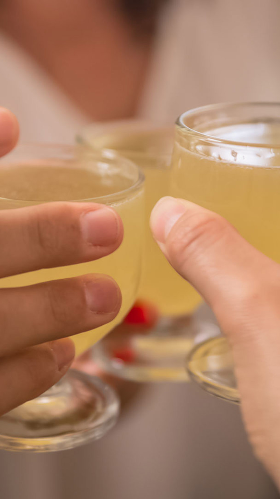 Brindis con poncha del pescador, manos levantando copas en la isla de Madeira.