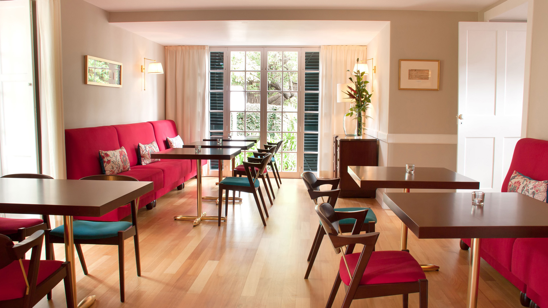 Red tables, chairs, and sofas arranged in the area.